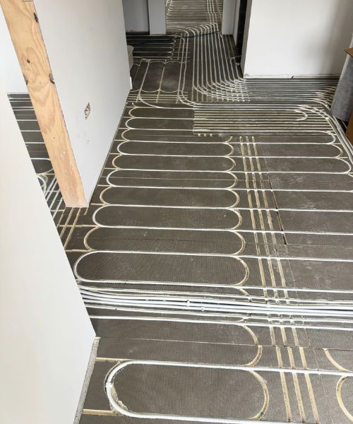 Pipework running through the hallway connecting multiple zones