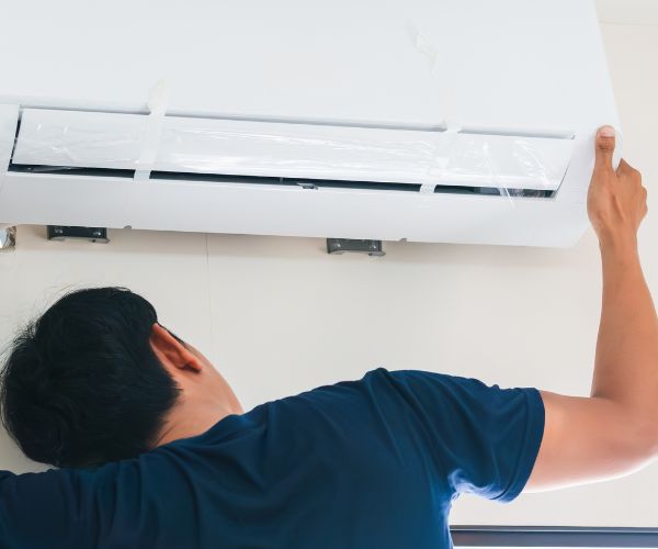 Air conditioning unit being mounted to the wall by engineer